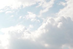 A serene view of thick, fluffy clouds set against a bright blue sky, perfect for backgrounds.